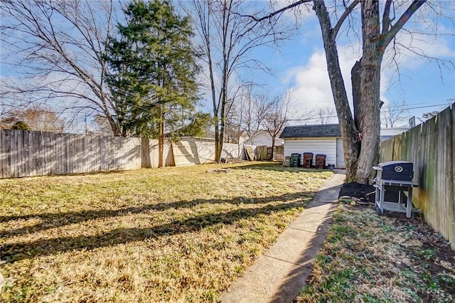 view of yard with an outdoor structure and a fenced backyard