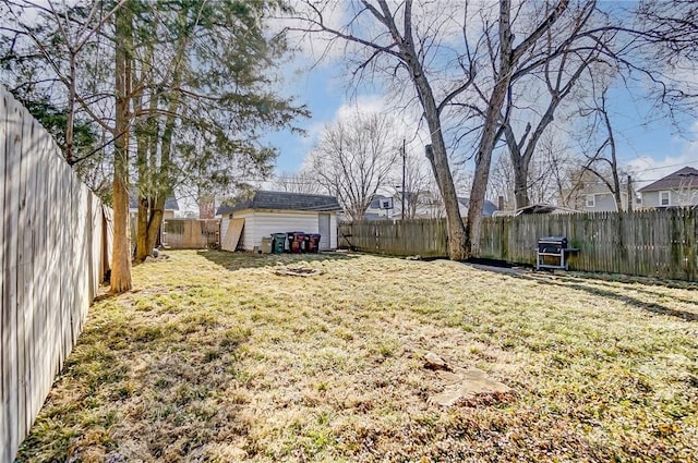 view of yard with a fenced backyard, a shed, and an outdoor structure