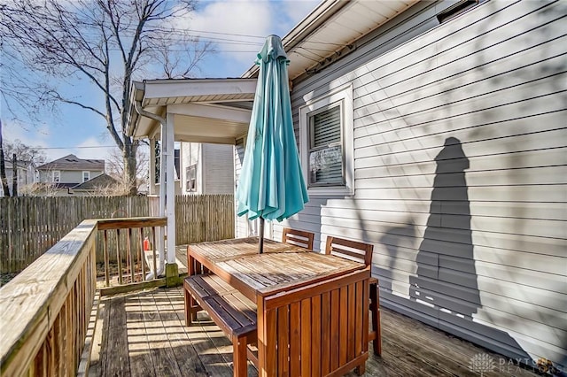 deck featuring outdoor dining area and fence