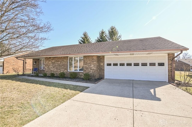 ranch-style house with driveway, a front yard, a shingled roof, a garage, and brick siding