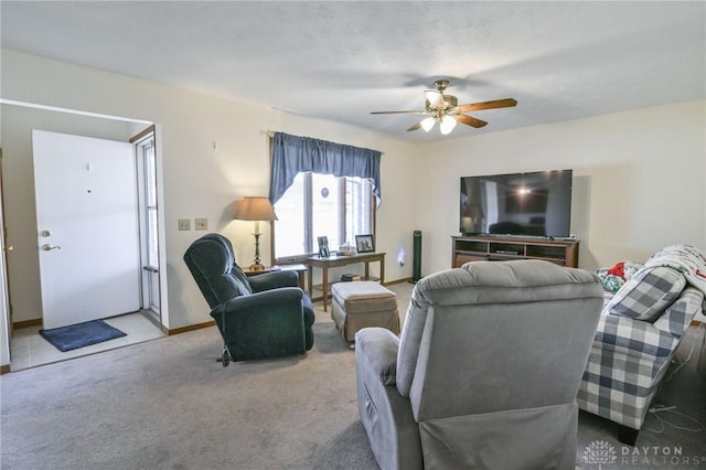 living area featuring baseboards, carpet, and ceiling fan