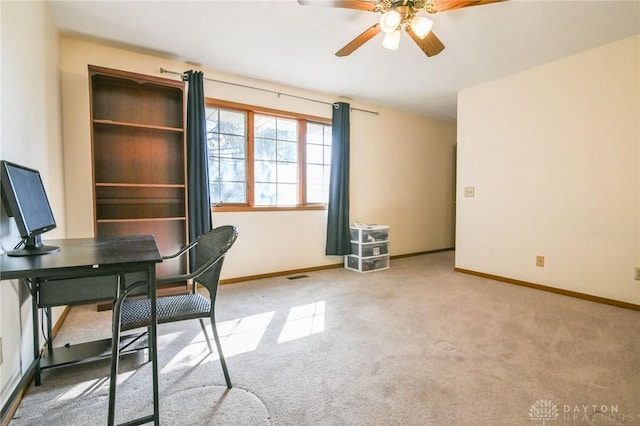 carpeted home office with visible vents, baseboards, and ceiling fan