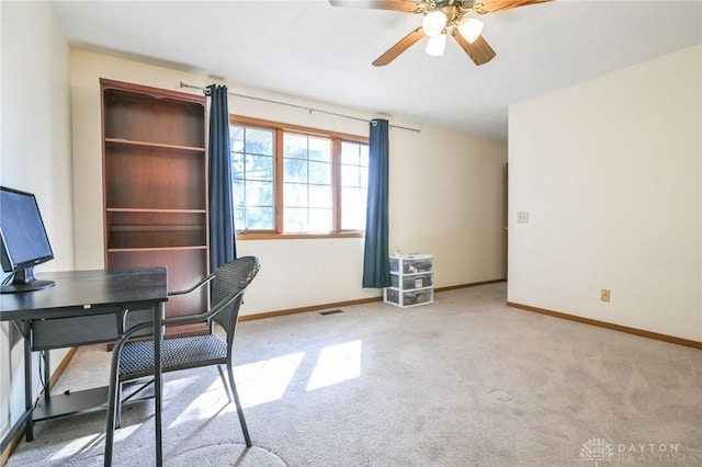 unfurnished office with visible vents, ceiling fan, baseboards, and carpet