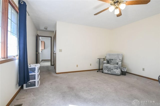 unfurnished room featuring carpet flooring, ceiling fan, and baseboards