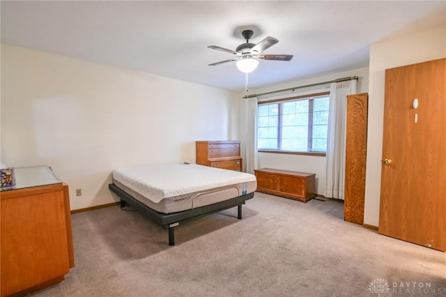 bedroom with baseboards, ceiling fan, and carpet flooring