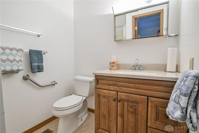 bathroom featuring tile patterned flooring, toilet, vanity, and baseboards