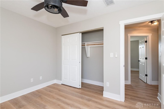 unfurnished bedroom featuring light wood-style floors, visible vents, a closet, and baseboards