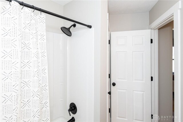 full bathroom with shower / bath combo with shower curtain