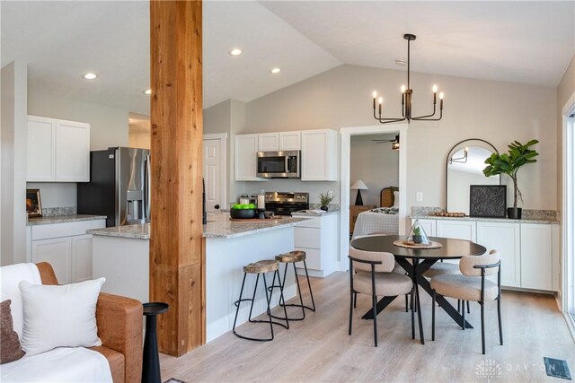 dining room with vaulted ceiling, light wood-style flooring, recessed lighting, and visible vents