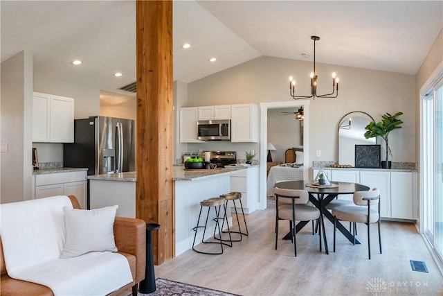 dining area featuring recessed lighting, visible vents, lofted ceiling, and light wood-style floors