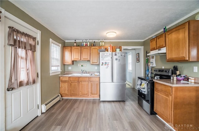 kitchen featuring under cabinet range hood, stainless steel appliances, light countertops, and a baseboard radiator