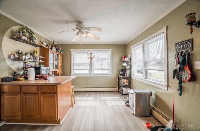 kitchen with a ceiling fan, brown cabinetry, a baseboard radiator, open shelves, and baseboard heating