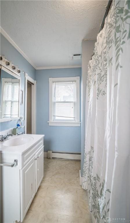 bathroom featuring vanity, visible vents, baseboard heating, and a textured ceiling
