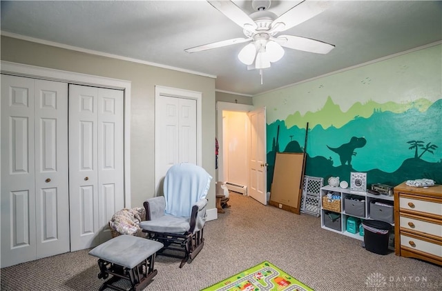 recreation room featuring a ceiling fan, crown molding, carpet, and a baseboard radiator