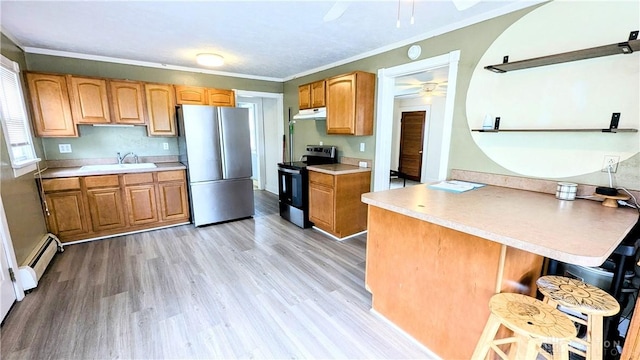134 S Harrison St, New Madison, OH 45346 - kitchen featuring appliances with stainless steel finishes, a ceiling fan, a baseboard heating unit, a peninsula, and a sink