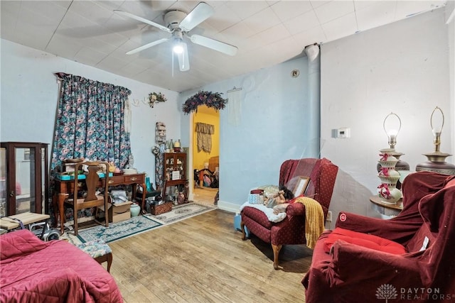 living room with wood finished floors and ceiling fan