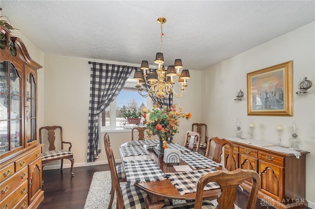 dining space with baseboards, a notable chandelier, dark wood-style flooring, and a textured ceiling