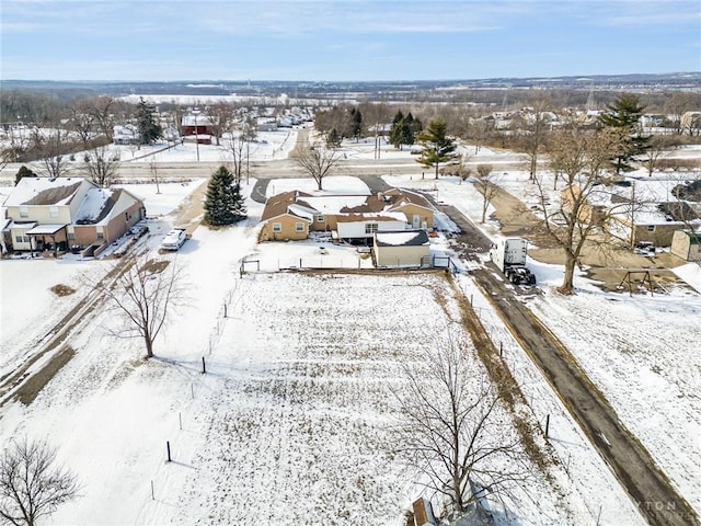 snowy aerial view featuring a residential view