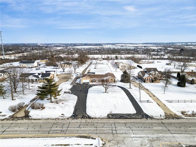 snowy aerial view featuring a residential view