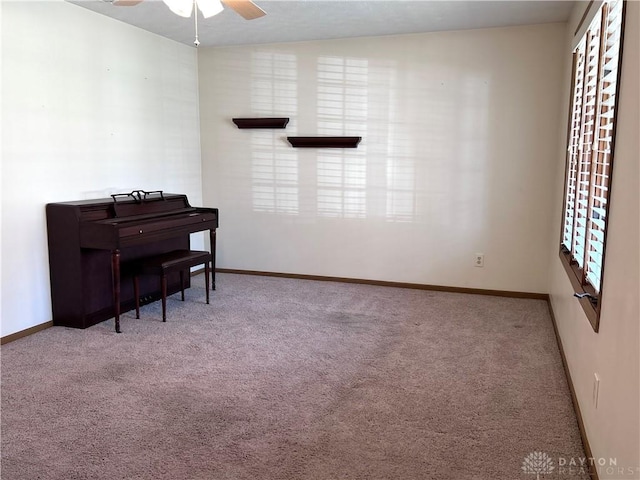 living area with carpet flooring, baseboards, and a wealth of natural light