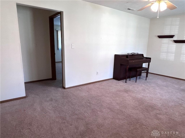 living area with visible vents, baseboards, and carpet