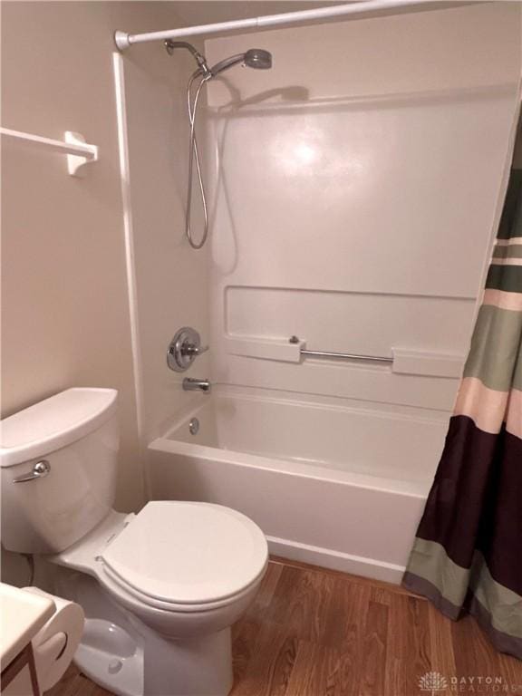 full bathroom featuring toilet, shower / bath combo, and wood finished floors