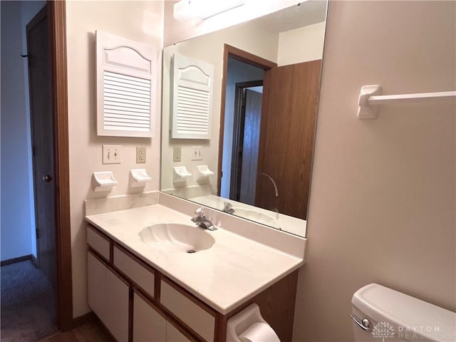 bathroom featuring vanity and toilet