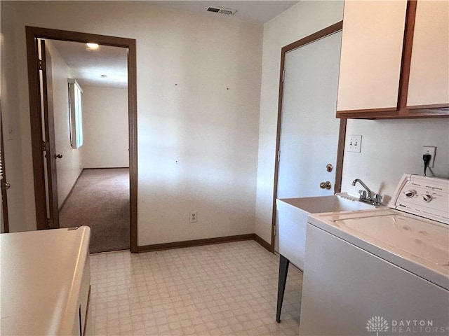 clothes washing area with visible vents, baseboards, light floors, cabinet space, and washer / clothes dryer