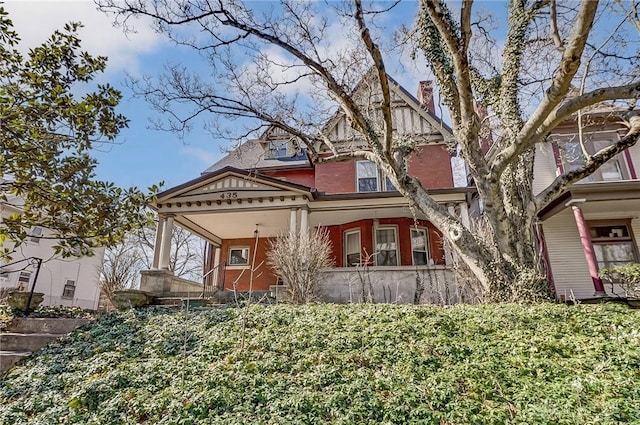 victorian-style house featuring brick siding