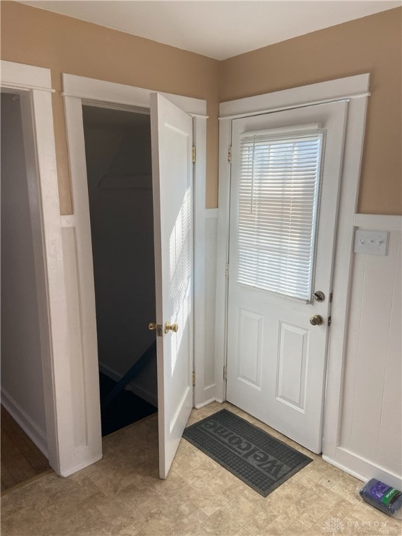 doorway with tile patterned floors