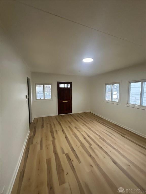 interior space with light wood-type flooring and baseboards