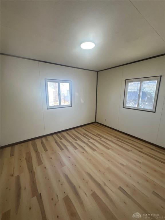 spare room featuring light wood-type flooring