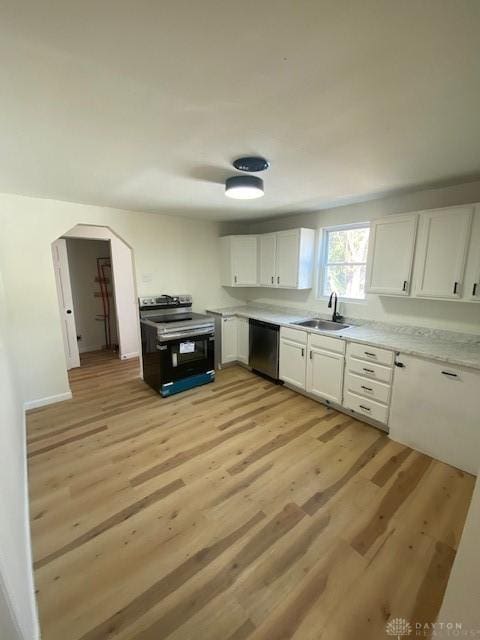 kitchen with light wood-type flooring, light countertops, stainless steel appliances, white cabinetry, and a sink