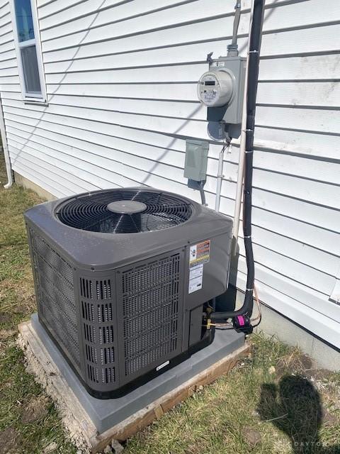 exterior details featuring cooling unit and electric meter