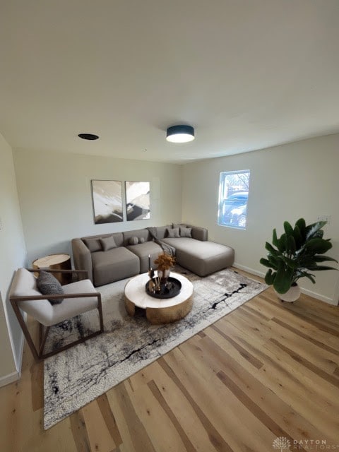 living area with wood finished floors and baseboards