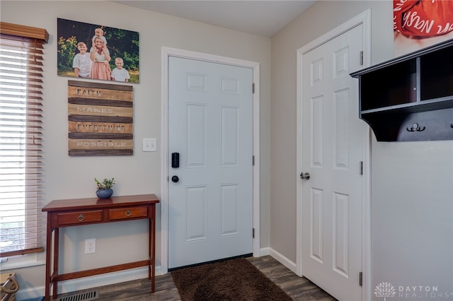 entryway with visible vents, baseboards, and dark wood-style flooring