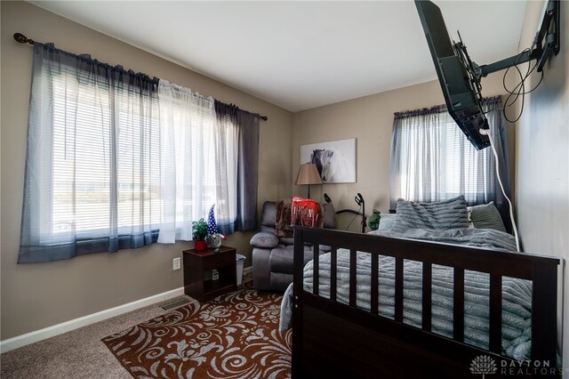 bedroom featuring baseboards and carpet floors