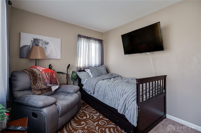 bedroom with baseboards and carpet floors