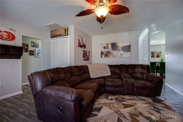 living area with visible vents, baseboards, a ceiling fan, and wood finished floors