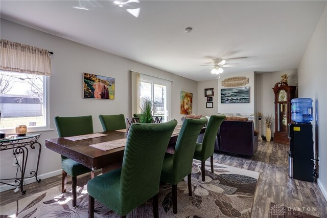 dining room featuring baseboards, ceiling fan, and wood finished floors