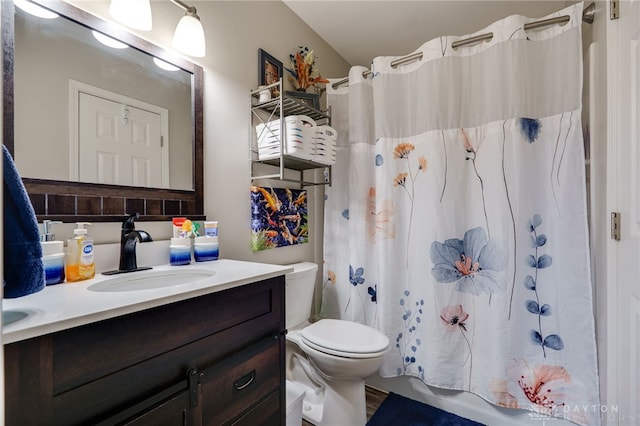 bathroom featuring toilet, vanity, and shower / bath combination with curtain