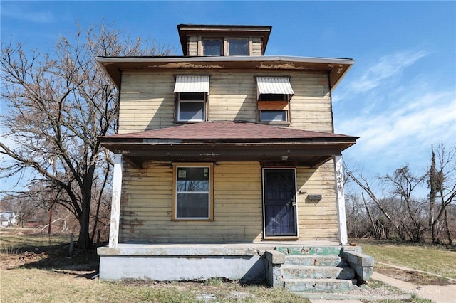 american foursquare style home featuring covered porch