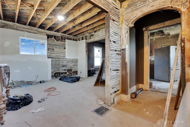 basement featuring freestanding refrigerator