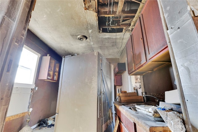 kitchen featuring a sink and freestanding refrigerator