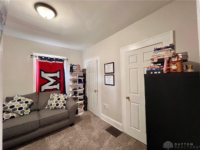 living room featuring visible vents, baseboards, and carpet