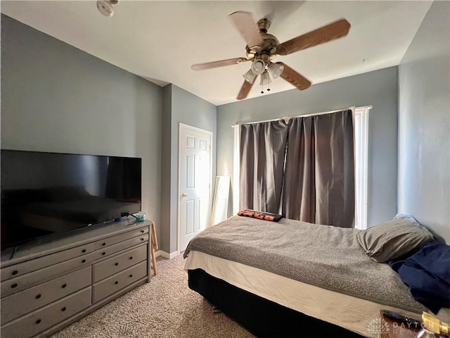 bedroom featuring baseboards, light colored carpet, and ceiling fan