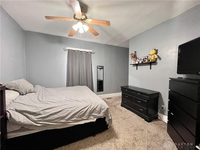 bedroom with baseboards, light colored carpet, and a ceiling fan