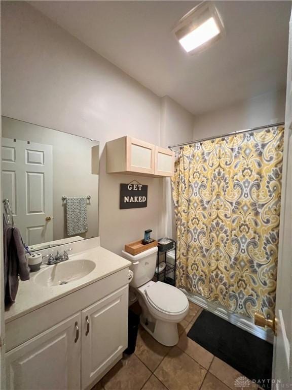 bathroom featuring toilet, vanity, and tile patterned flooring