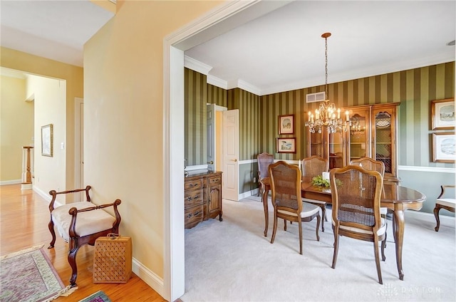 dining room featuring visible vents, baseboards, a chandelier, and wallpapered walls