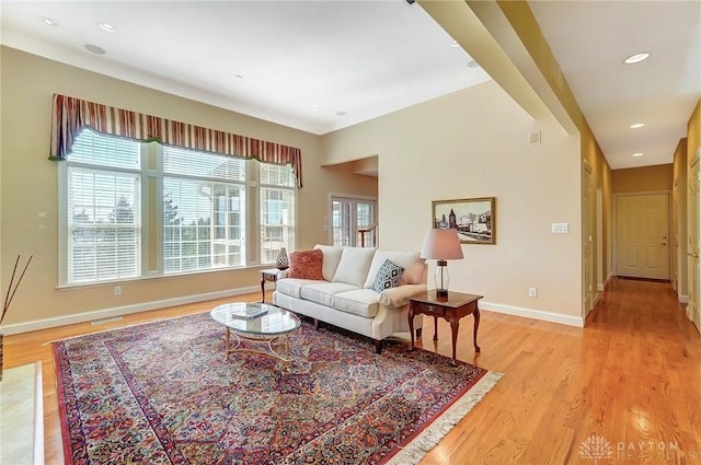 living area with light wood finished floors, visible vents, recessed lighting, and baseboards